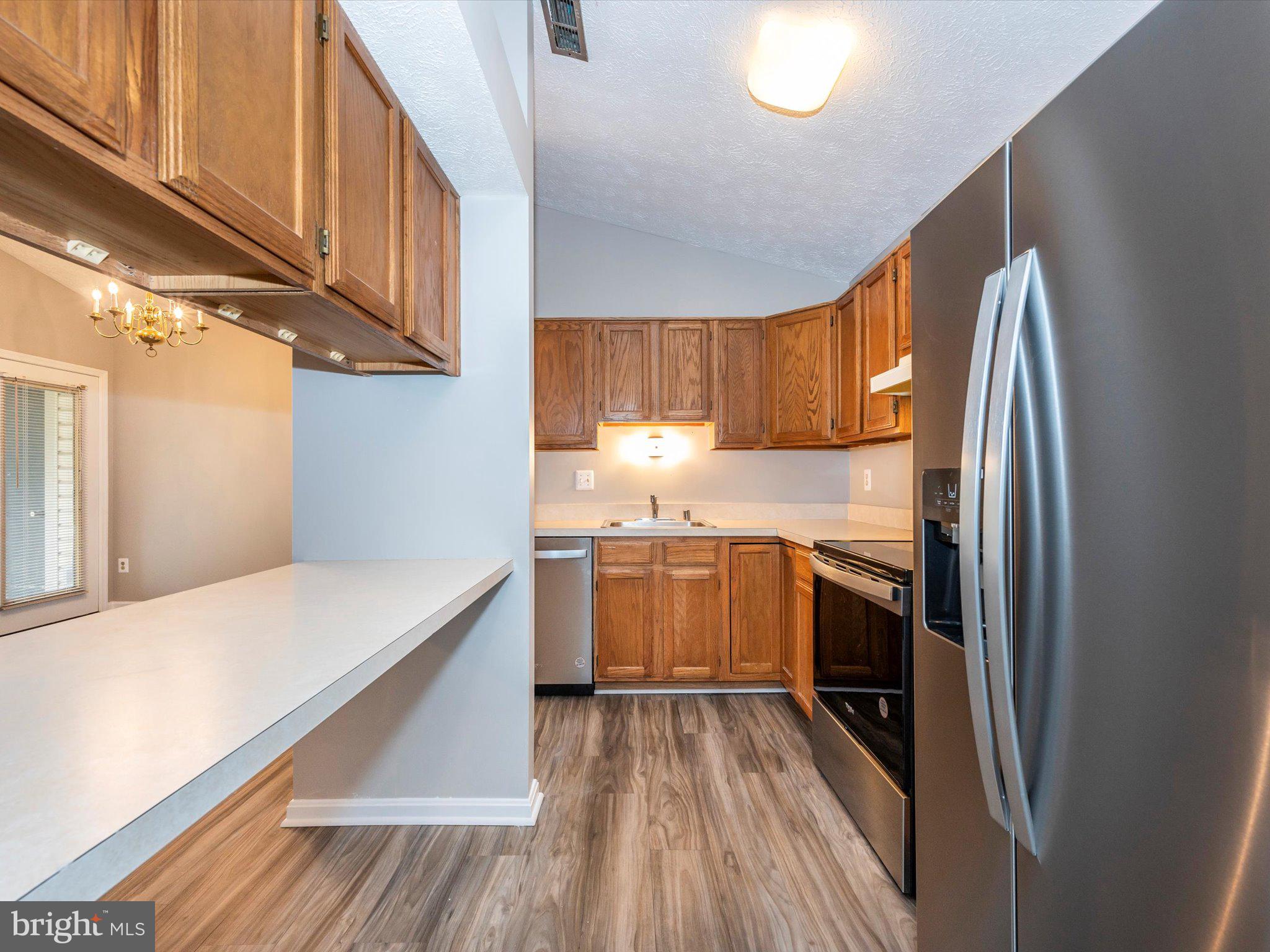 2112 Whitehall Road, Unit 2C Frederick, MD 21702 - Photo 26 of 59 a kitchen with a sink a refrigerator and wooden floor