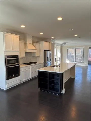 a kitchen with a sink stainless steel appliances and cabinets