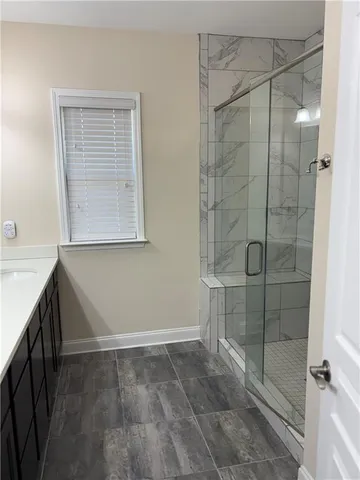 a bathroom with a sink a mirror and a shower