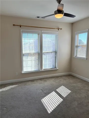 a bathroom with a sink a toilet a mirror and shower