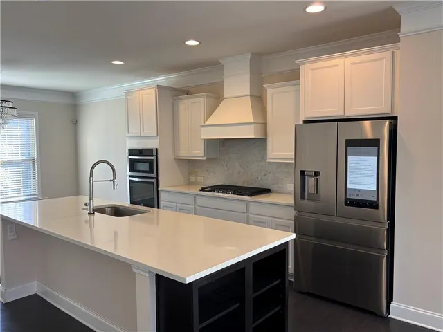 a kitchen with a refrigerator and a sink