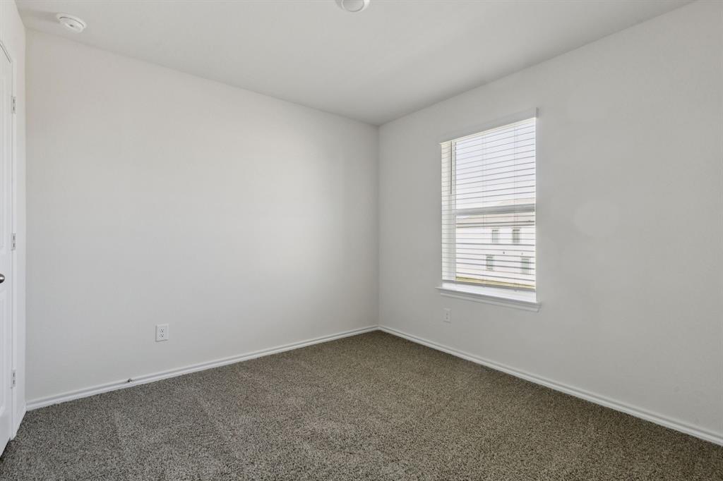 317 Clematis Street Princeton, TX 75407 - Photo 25 of 38 Carpeted empty room with baseboards