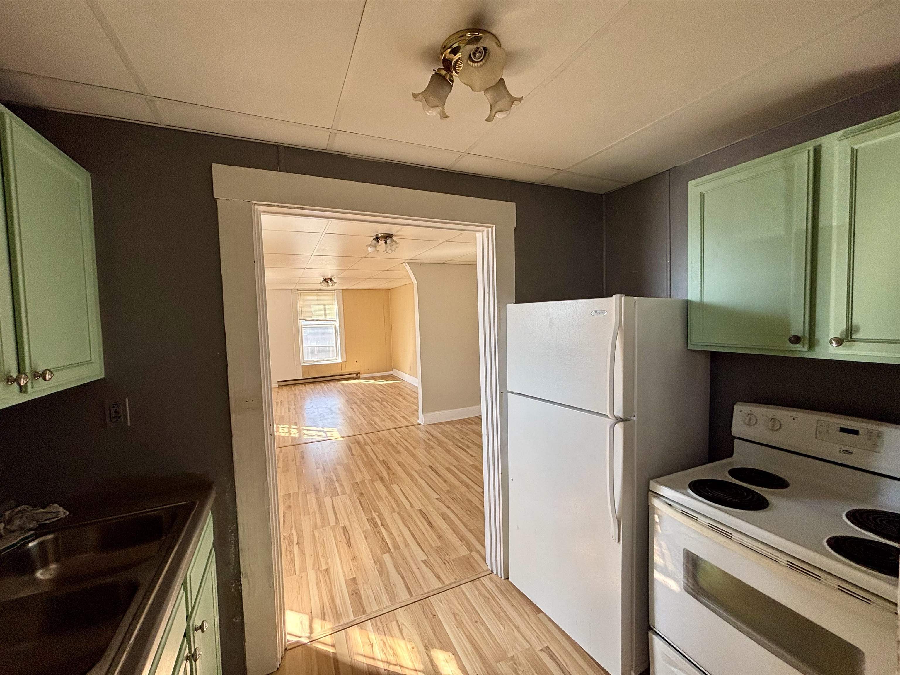 101 West Market Street Mount Carroll, IL 61053 - Photo 13 of 26 a white refrigerator freezer and a stove sitting inside of a kitchen