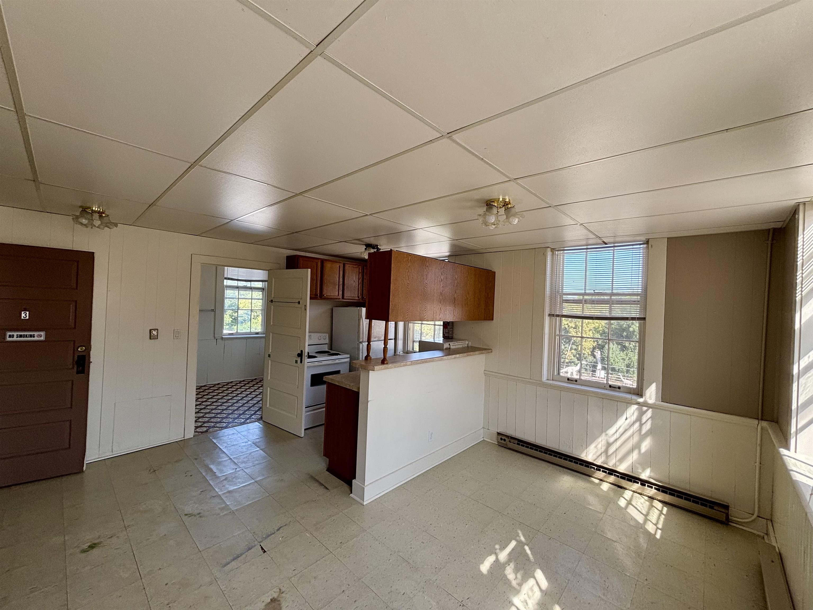 101 West Market Street Mount Carroll, IL 61053 - Photo 15 of 26 a kitchen with stainless steel appliances granite countertop a refrigerator and a stove top oven