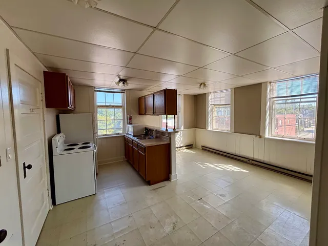 a kitchen with refrigerator and window