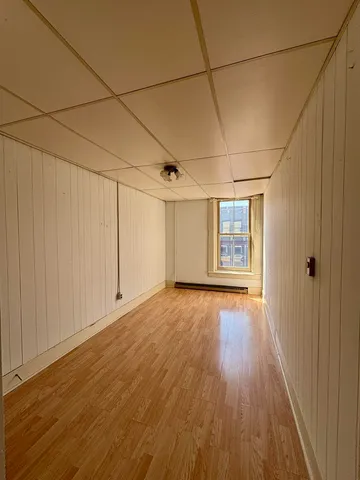 a view of a room with wooden floors