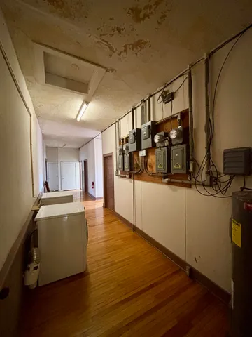 a view of a kitchen with furniture and wooden floor
