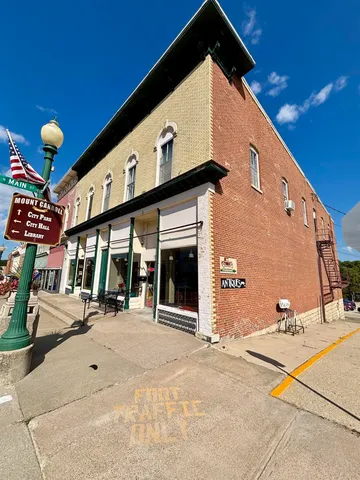 a front view of a building with glass windows and door