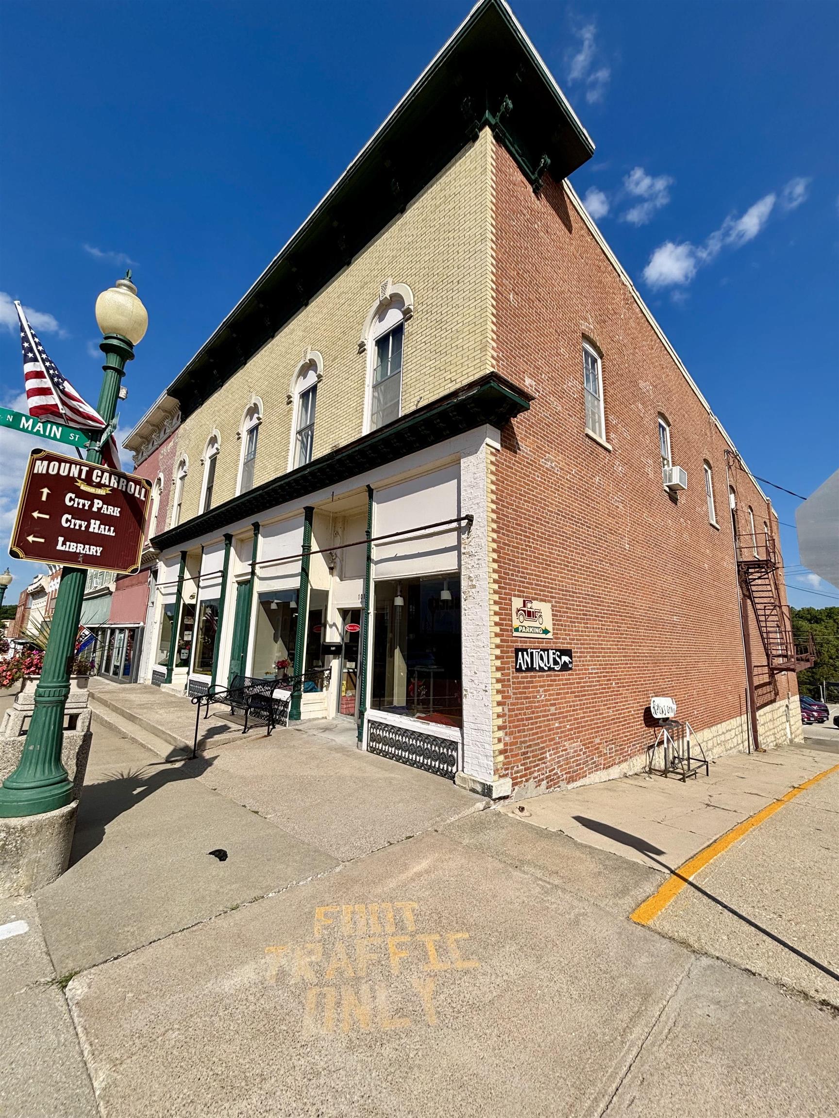 101 West Market Street Mount Carroll, IL 61053 - Photo 24 of 26 a front view of a building with glass windows and door