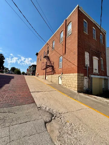 a view of a balcony with chairs and a stove
