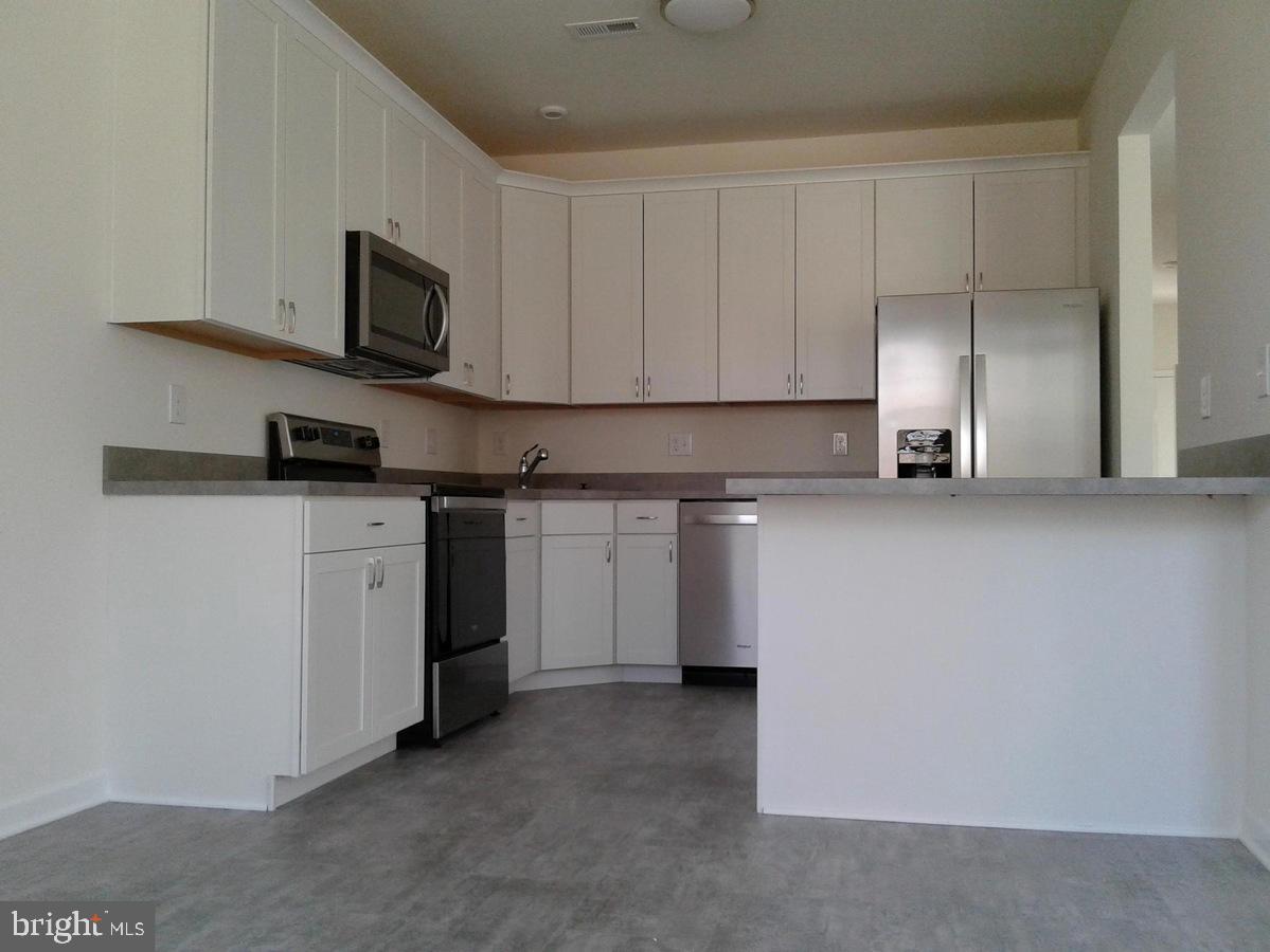 131 Cooper Folly Road Atco, NJ 08004 - Photo 3 of 26 a kitchen with stainless steel appliances granite countertop a stove a sink and a microwave