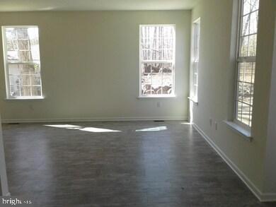 131 Cooper Folly Road Atco, NJ 08004 - Photo 7 of 26 an empty room with wooden floor and windows