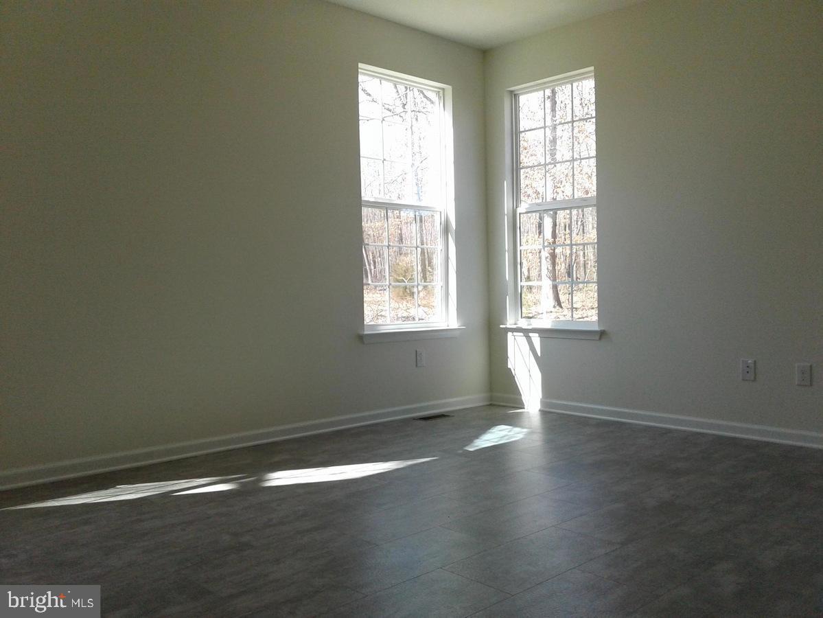 131 Cooper Folly Road Atco, NJ 08004 - Photo 8 of 26 an empty room with wooden floor and windows