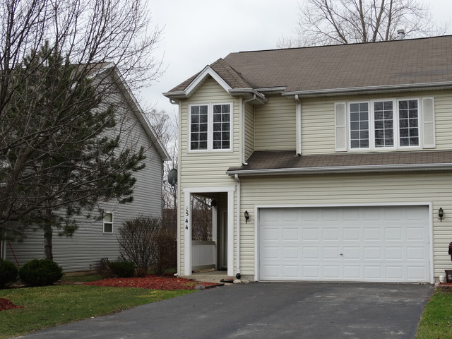 544 Birch Road Woodstock, IL 60098 - Photo 1 of 25 a front view of a house with a yard and garage