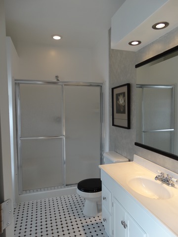 544 Birch Road Woodstock, IL 60098 - Photo 19 of 25 a bathroom with a sink a toilet and shower