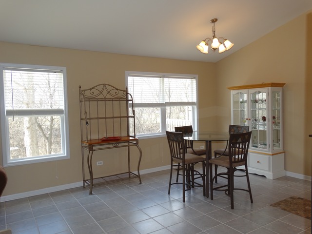 544 Birch Road Woodstock, IL 60098 - Photo 3 of 25 a view of a dining room with furniture and chandelier