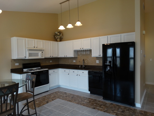 544 Birch Road Woodstock, IL 60098 - Photo 5 of 25 a kitchen with a sink and cabinets