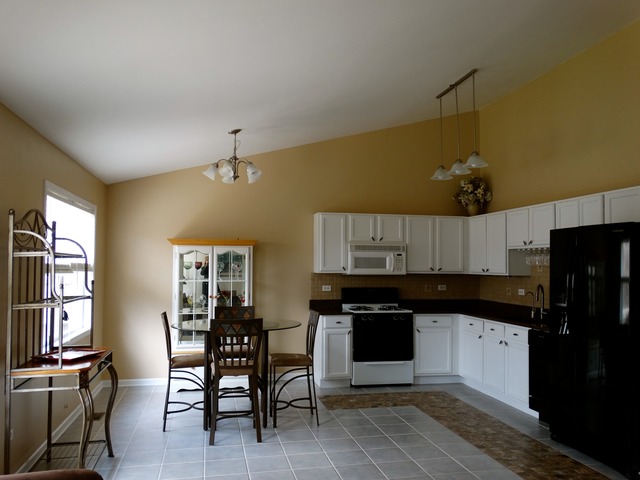 544 Birch Road Woodstock, IL 60098 - Photo 6 of 25 a kitchen with granite countertop a sink cabinets and stainless steel appliances