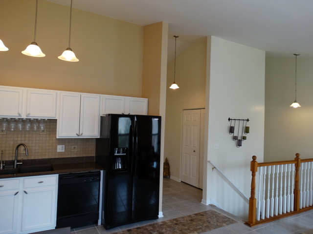544 Birch Road Woodstock, IL 60098 - Photo 7 of 25 a kitchen with a sink stainless steel appliances and cabinets