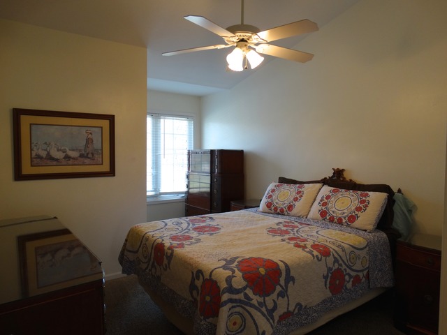 544 Birch Road Woodstock, IL 60098 - Photo 10 of 25 a bedroom with a bed and a lamp on dresser