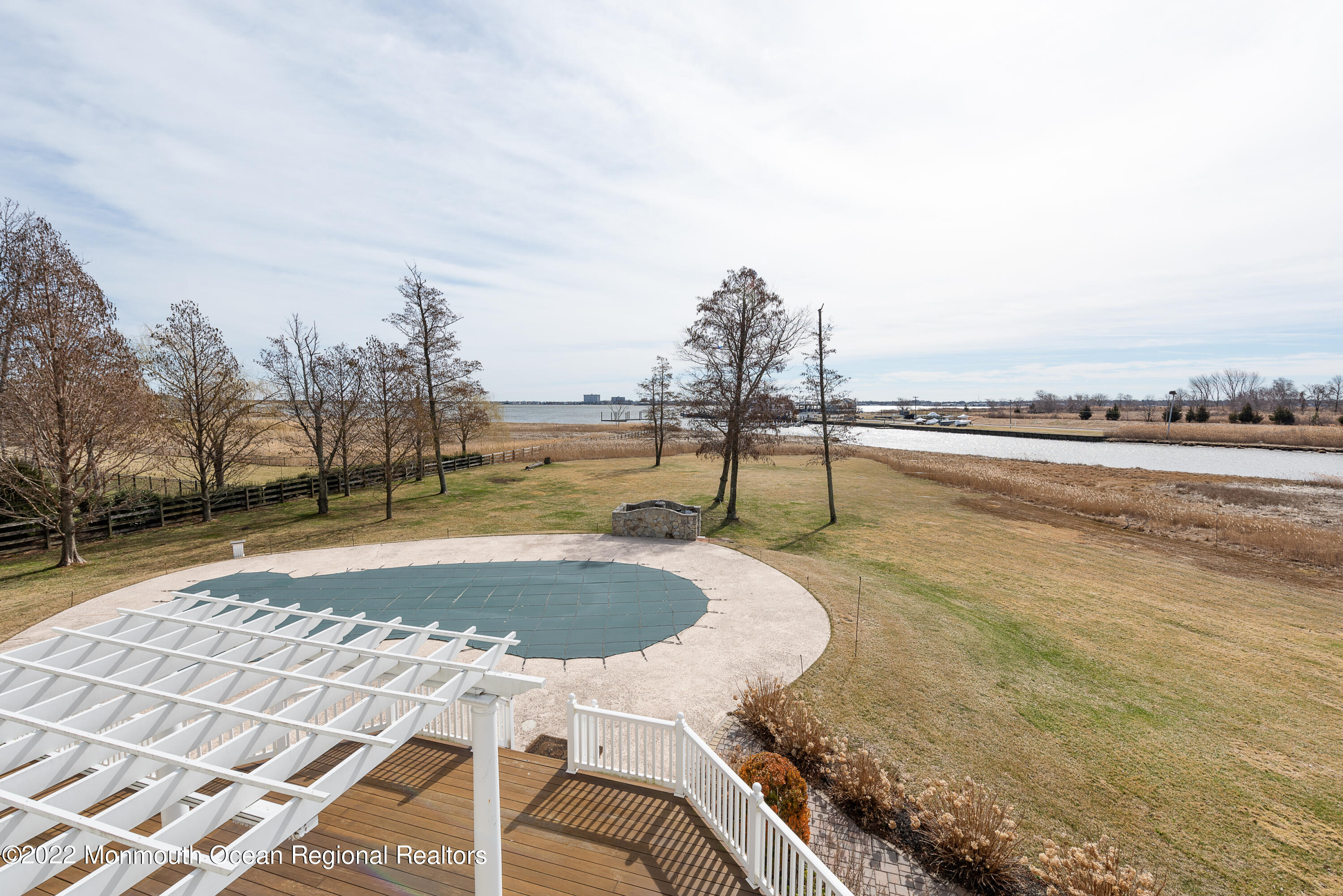 24 Conover Lane Rumson, NJ 07760 - Photo 33 of 39 a swimming pool with outdoor seating and city view