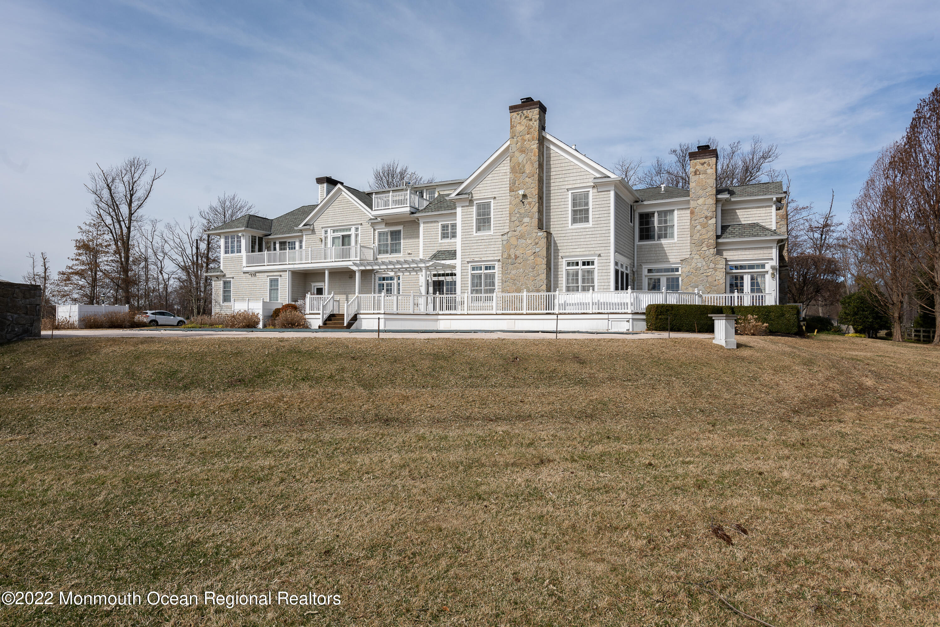 24 Conover Lane Rumson, NJ 07760 - Photo 34 of 39 a front view of a building with a yard