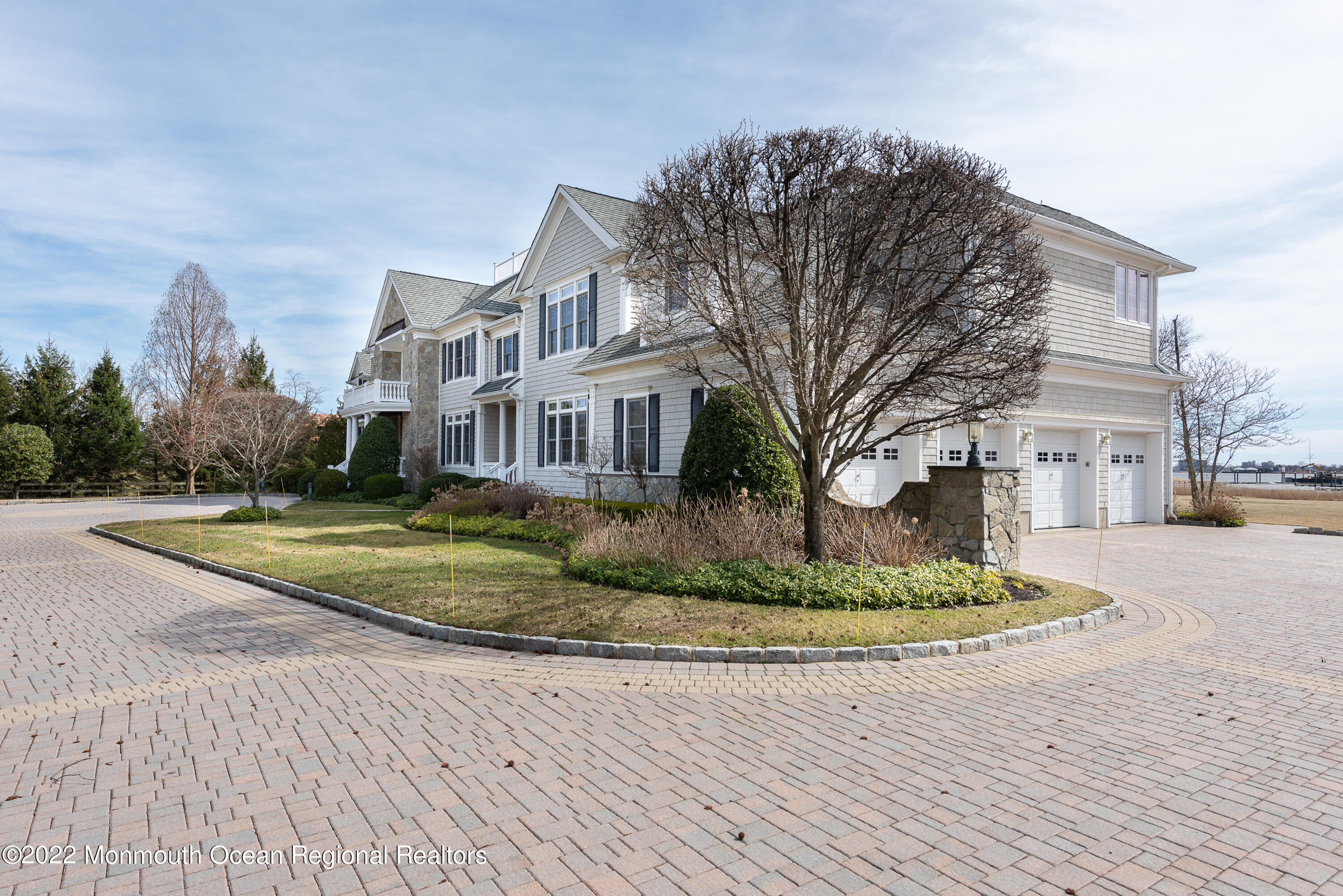 24 Conover Lane Rumson, NJ 07760 - Photo 4 of 39 a view of a white house next to a yard with big trees