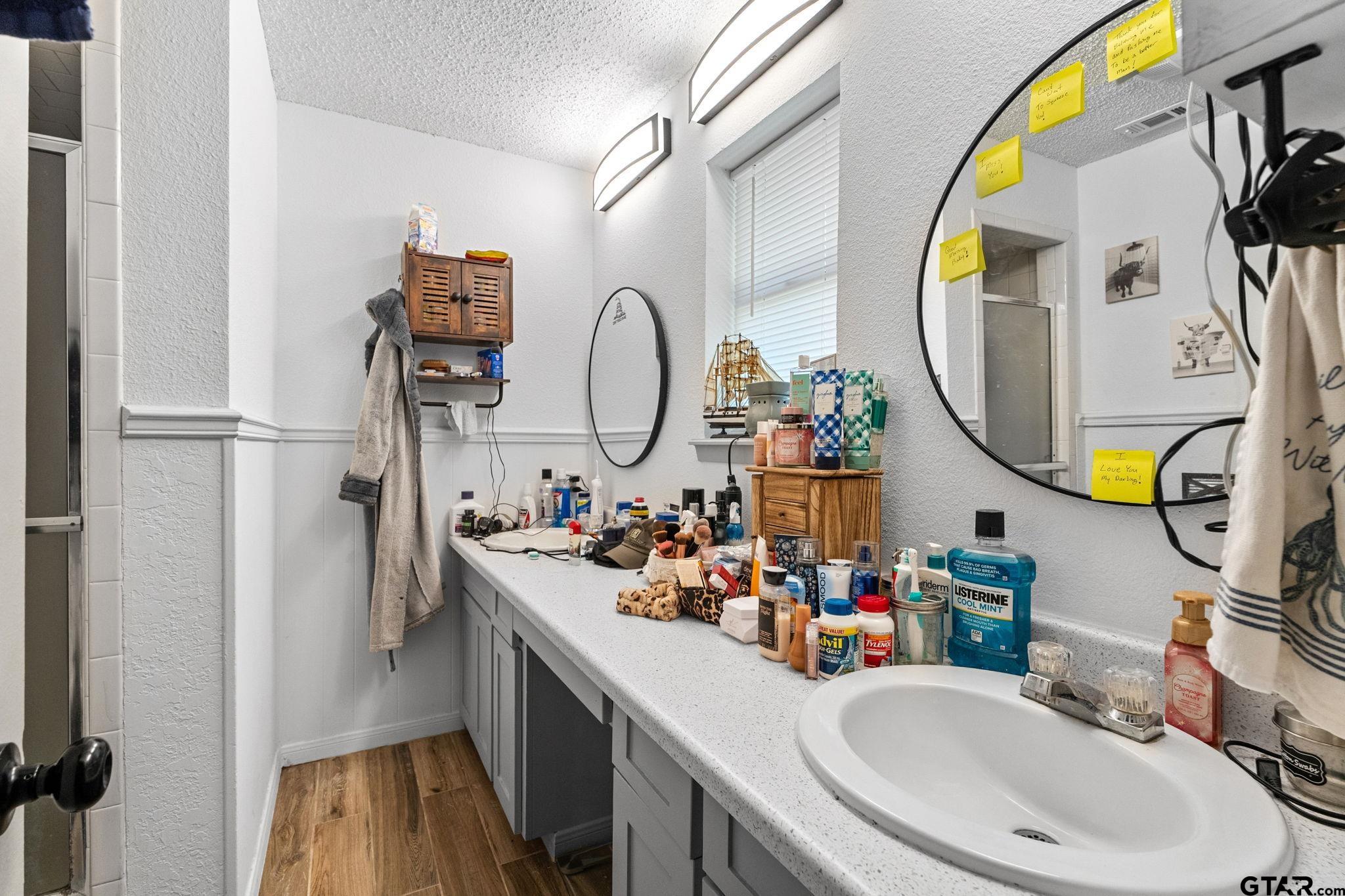 7649 Timber Circle Tyler, TX 75708 - Photo 12 of 25 a bathroom with a sink mirror and vanity