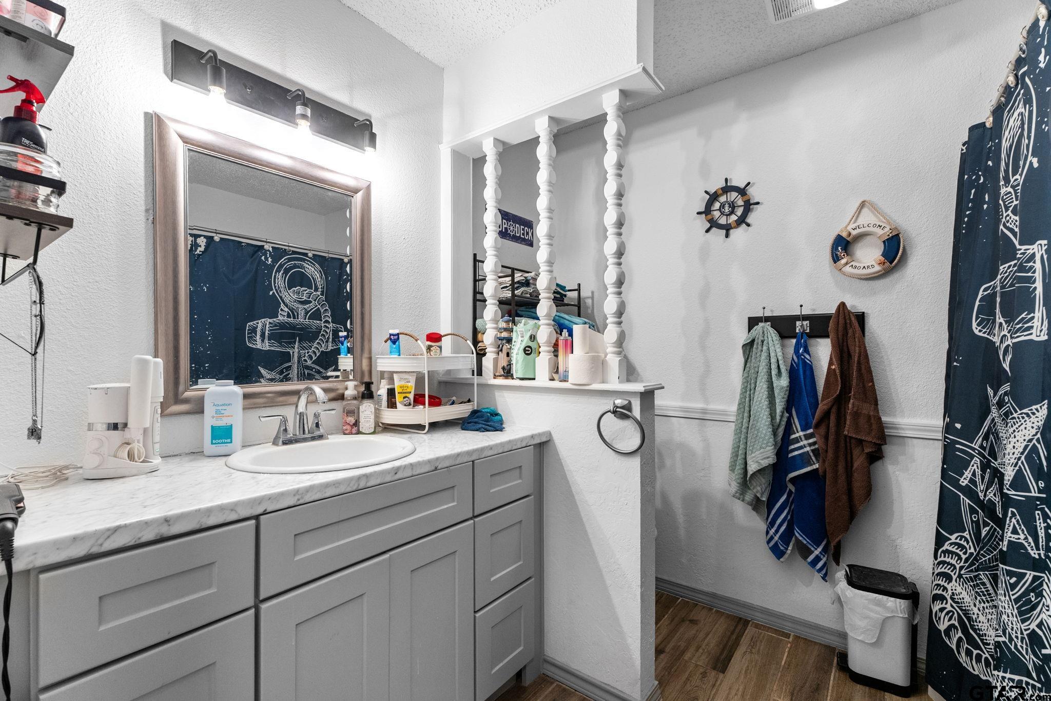 7649 Timber Circle Tyler, TX 75708 - Photo 16 of 25 a bathroom with a double vanity sink and a mirror