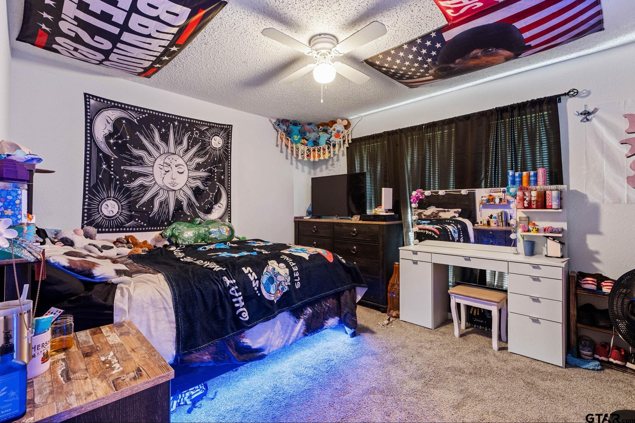 7649 Timber Circle Tyler, TX 75708 - Photo 18 of 25 a bedroom with bed and a chandelier