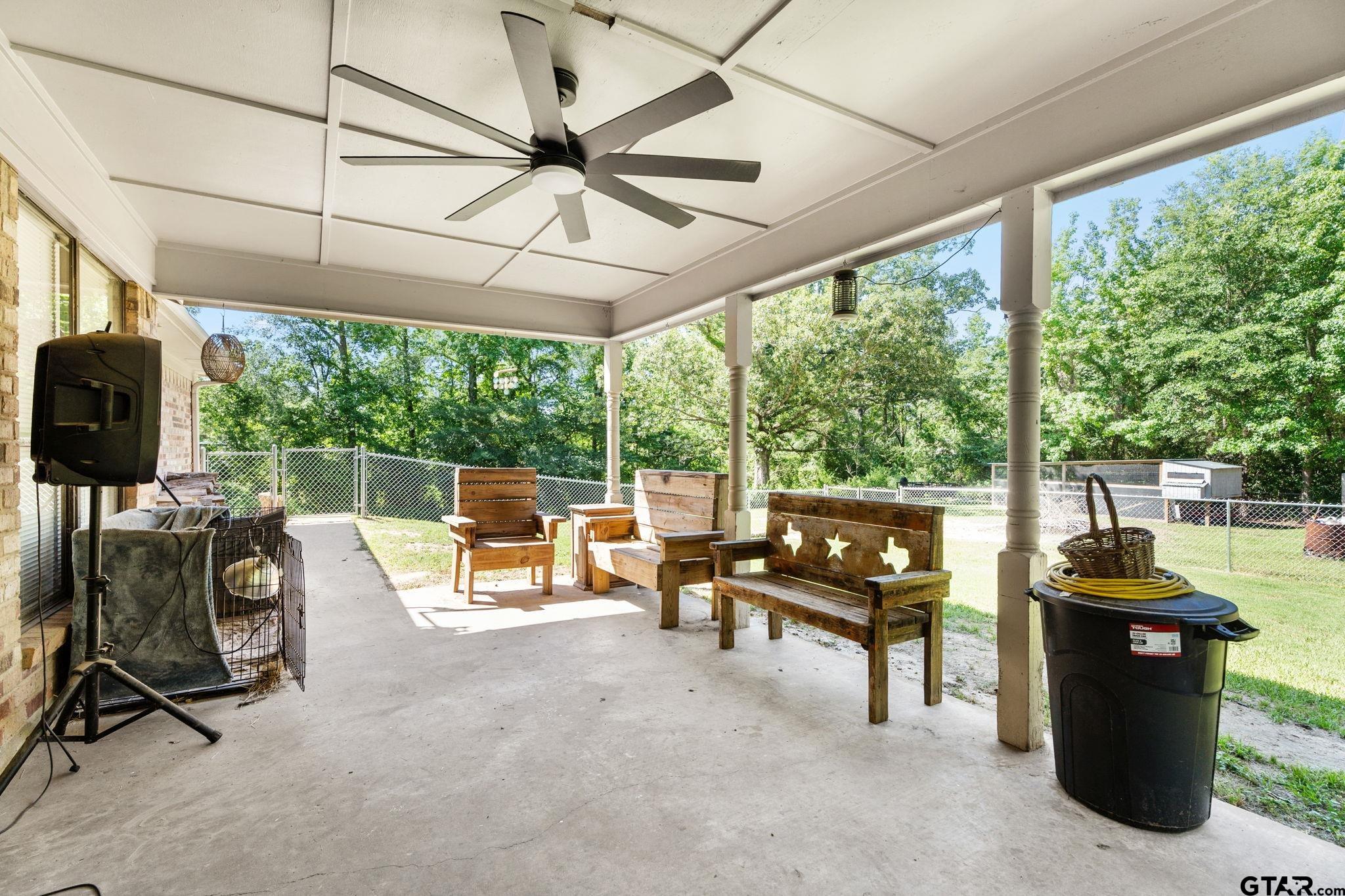 7649 Timber Circle Tyler, TX 75708 - Photo 20 of 25 a living room with furniture and a floor to ceiling window