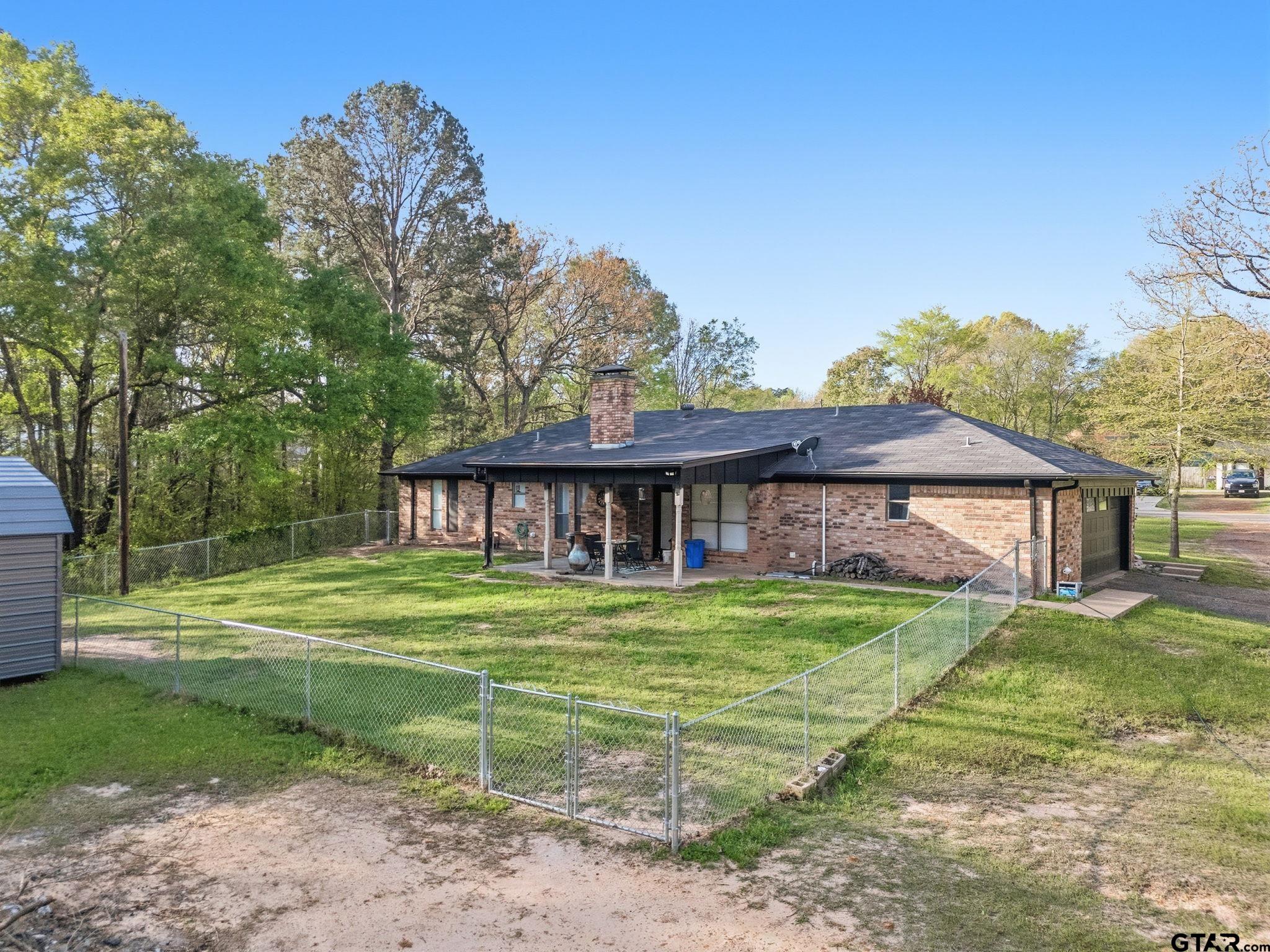 7649 Timber Circle Tyler, TX 75708 - Photo 22 of 25 a front view of a house with a yard