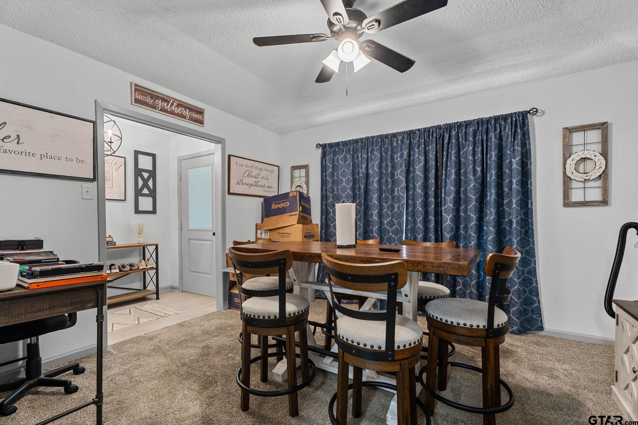 7649 Timber Circle Tyler, TX 75708 - Photo 8 of 25 a view of a dining room with furniture and a chandelier
