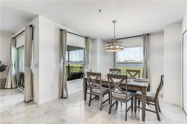 a view of a dining room with furniture and window