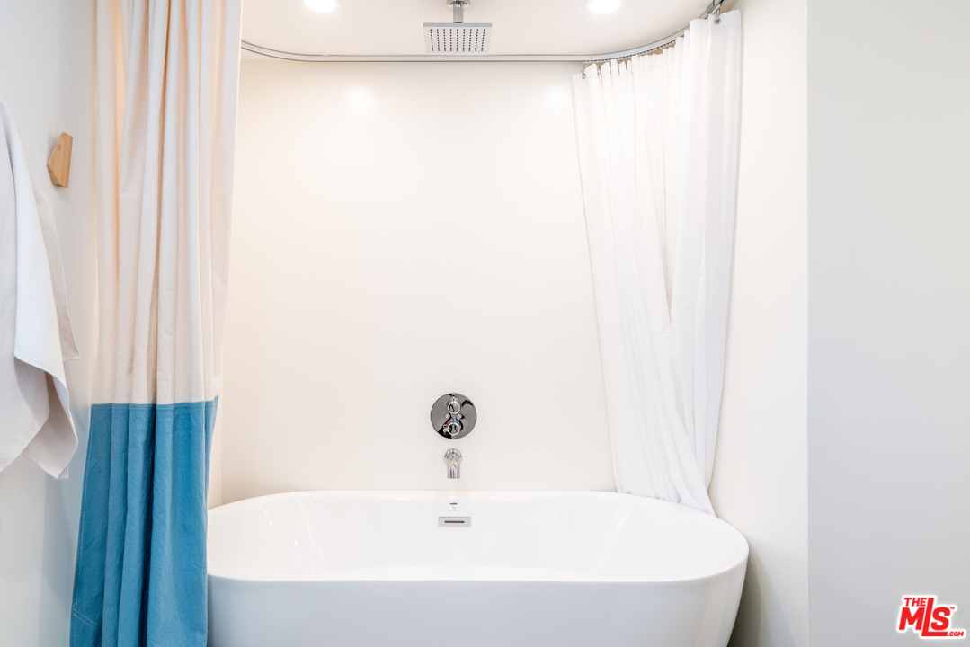 31034 Broad Beach Road Malibu, CA 90265 - Photo 11 of 21 a white bath tub sitting next to a white shower curtain