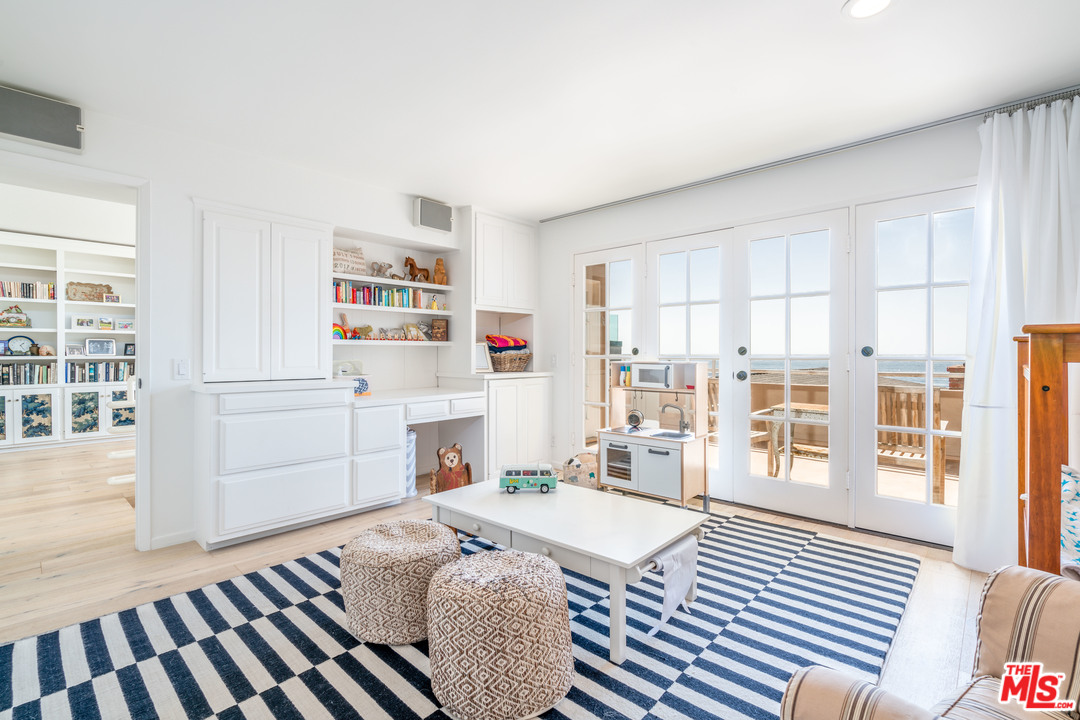 31034 Broad Beach Road Malibu, CA 90265 - Photo 14 of 21 a living room with furniture fireplace and wooden floor