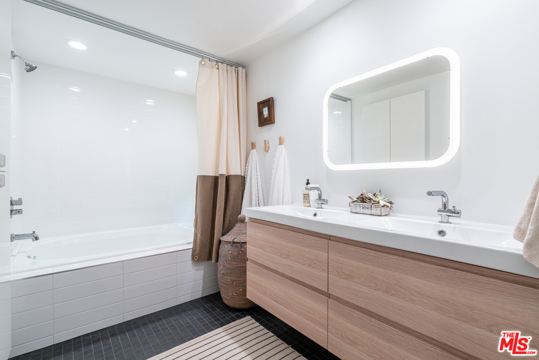 31034 Broad Beach Road Malibu, CA 90265 - Photo 17 of 21 a bathroom with a bathtub sink vanity and mirror