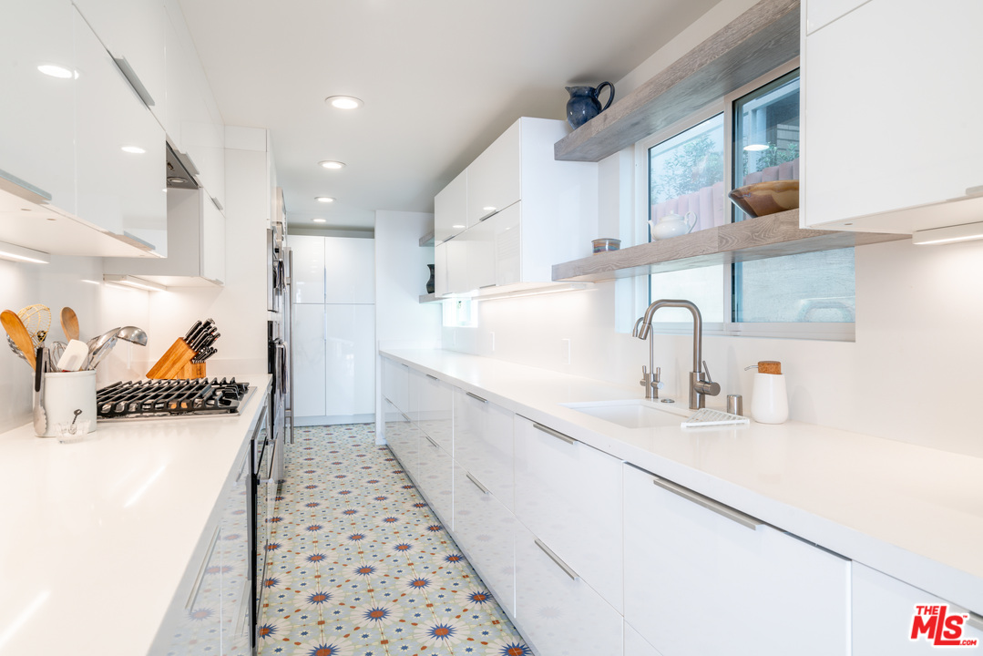 31034 Broad Beach Road Malibu, CA 90265 - Photo 4 of 21 a kitchen with granite countertop a sink and a refrigerator