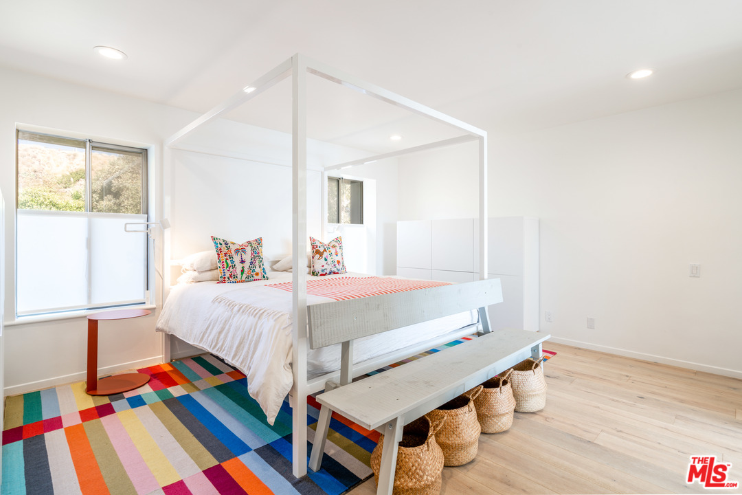31034 Broad Beach Road Malibu, CA 90265 - Photo 10 of 21 a bedroom with a bed and a lamp on the dresser