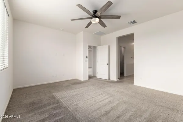 a view of an empty room with a ceiling fan