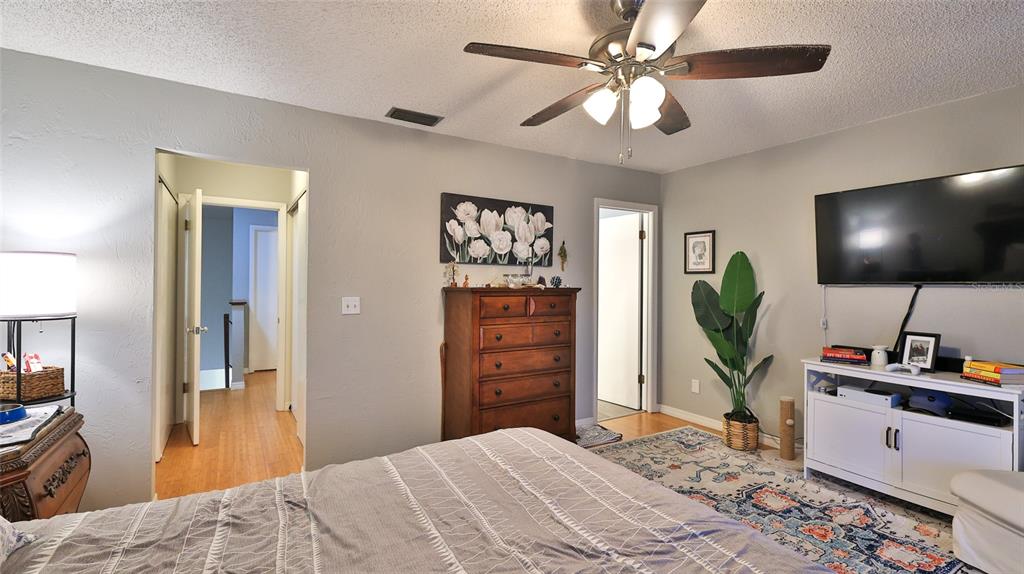 4740 South Atlantic Avenue, Unit 4 Ponce Inlet, FL 32127 - Photo 14 of 38 a bedroom with a bed and a flat screen tv