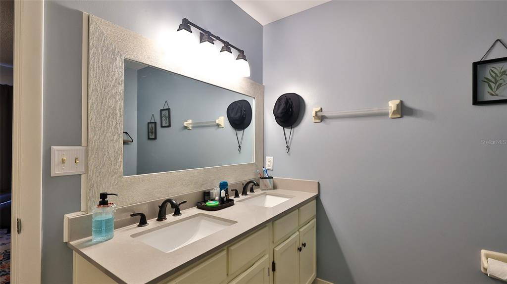 4740 South Atlantic Avenue, Unit 4 Ponce Inlet, FL 32127 - Photo 15 of 38 a bathroom with a sink and a mirror