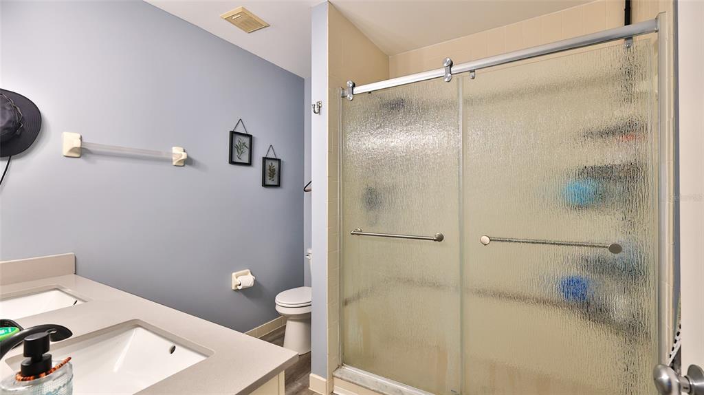 4740 South Atlantic Avenue, Unit 4 Ponce Inlet, FL 32127 - Photo 16 of 38 a bathroom with a shower and a toilet