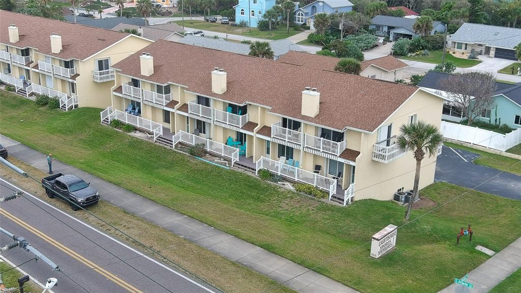 4740 South Atlantic Avenue, Unit 4 Ponce Inlet, FL 32127 - Photo 2 of 38 a view of building with yard