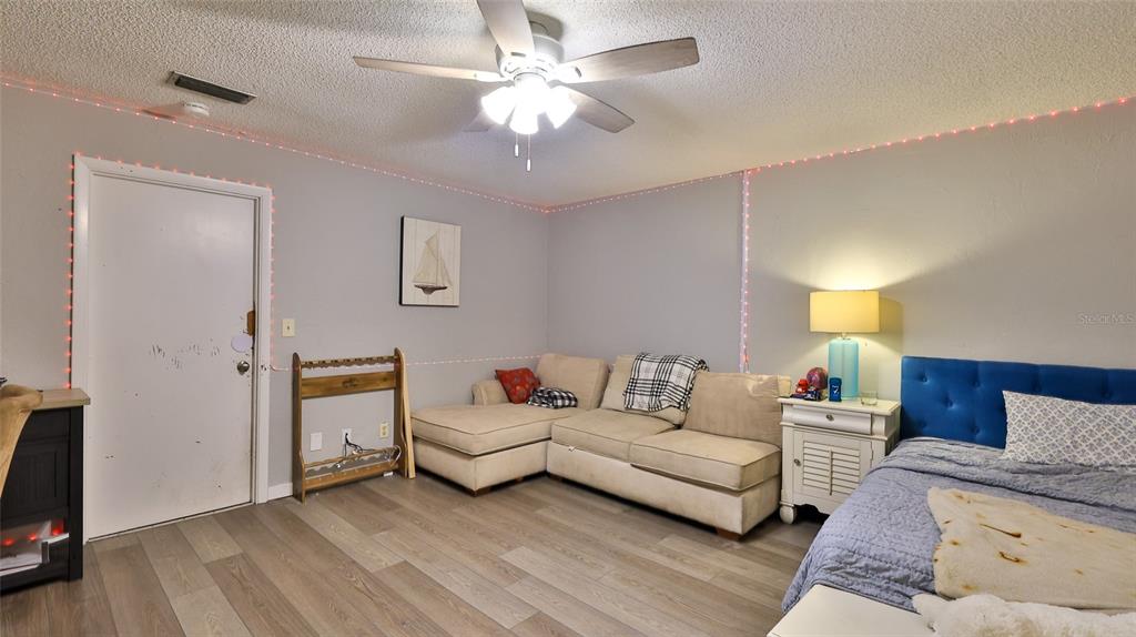 4740 South Atlantic Avenue, Unit 4 Ponce Inlet, FL 32127 - Photo 22 of 38 a living room with furniture and a flat screen tv