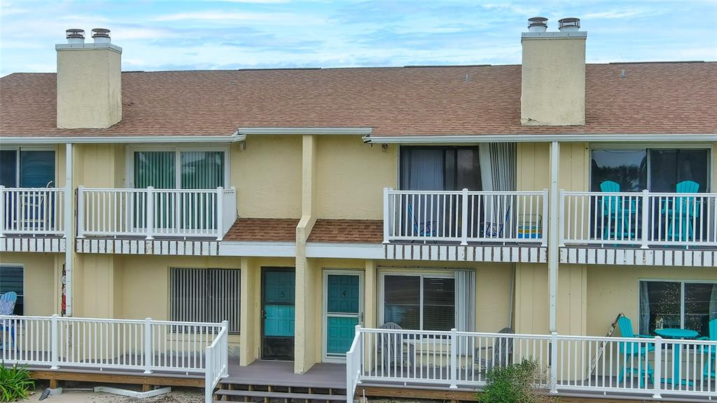 4740 South Atlantic Avenue, Unit 4 Ponce Inlet, FL 32127 - Photo 28 of 38 a front view of a house having yard