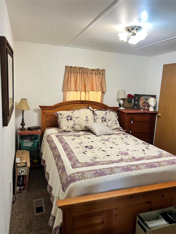3400 Surfside Drive May, TX 76857 - Photo 33 of 39 a bedroom with a bed and wooden floor