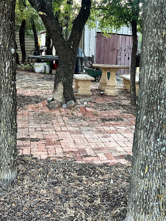 3400 Surfside Drive May, TX 76857 - Photo 5 of 39 a view of a backyard with wooden fence and a large tree