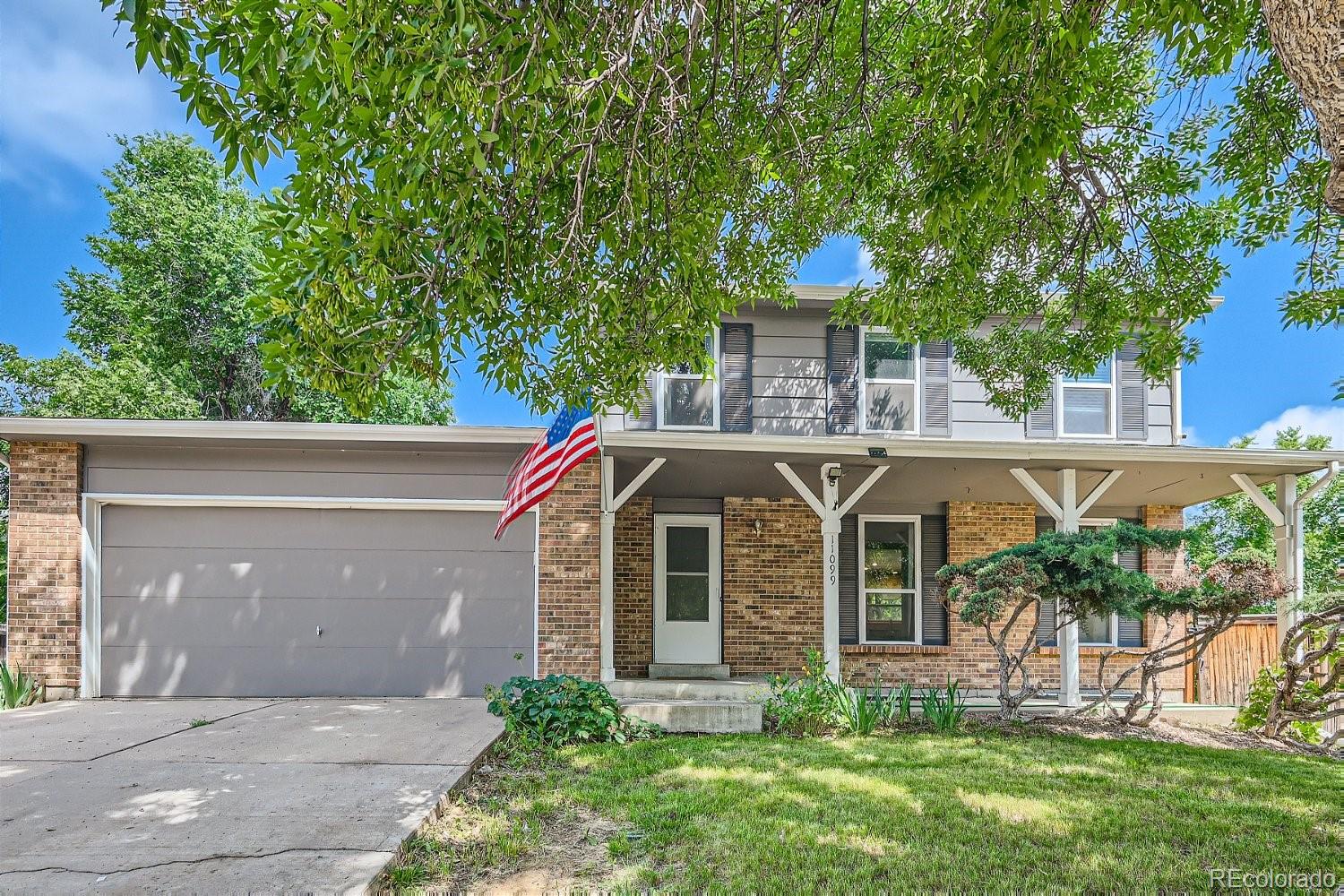 11099 Fairfax Circle Thornton, CO 80233 - Photo 1 of 33 a front view of a house with garden