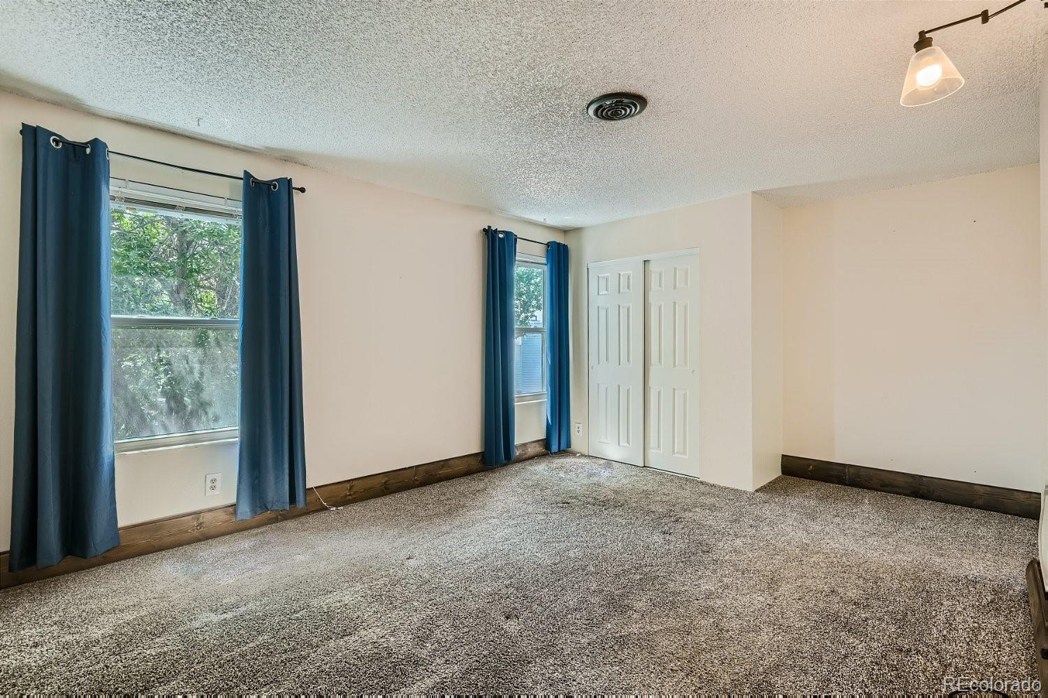 11099 Fairfax Circle Thornton, CO 80233 - Photo 20 of 33 a view of an empty room with closet and a window